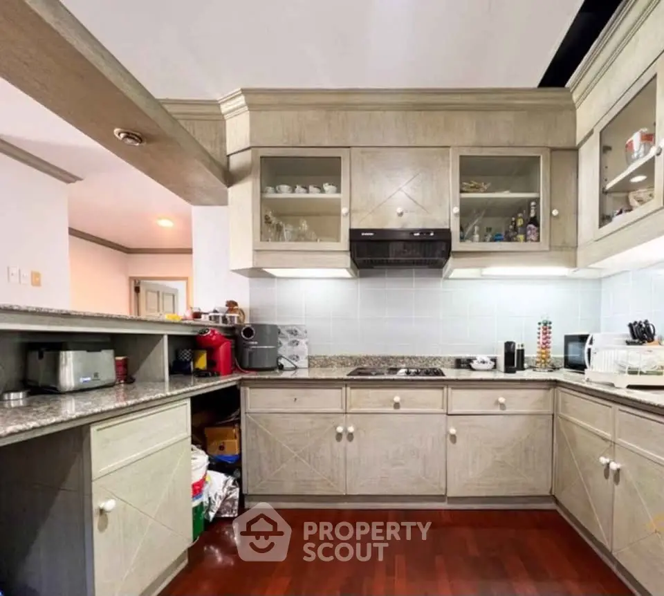 Spacious kitchen with modern appliances and wooden cabinetry