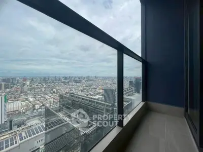 Stunning high-rise balcony with panoramic cityscape view, perfect for urban living enthusiasts.