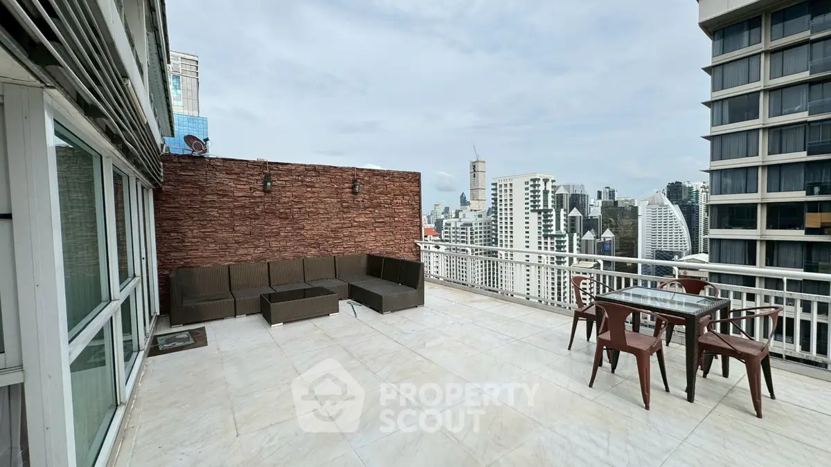 Spacious rooftop terrace with city skyline views and outdoor seating area.