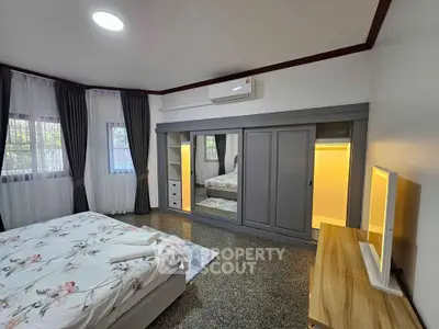 Spacious bedroom with modern decor and ample natural light