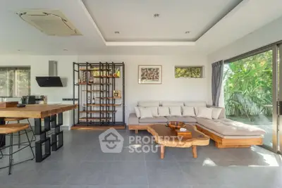 Spacious modern living room with natural light and stylish furniture, perfect for relaxation and entertaining.