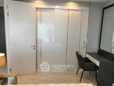 Modern bedroom with sleek wardrobe and stylish desk chair
