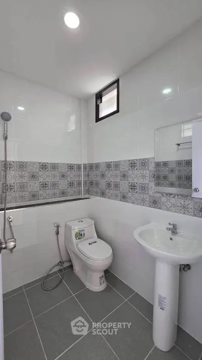 Modern bathroom with stylish tile accents and sleek fixtures in a contemporary home.