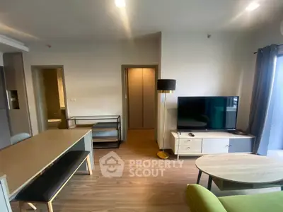 Modern living room with stylish furniture and large TV, perfect for relaxation and entertainment.