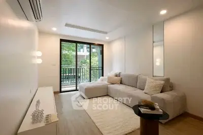 Modern living room with cozy sofa and balcony view in a stylish apartment.