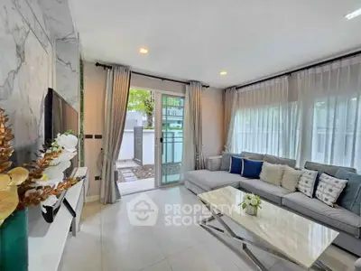 Modern living room with elegant decor and large windows for natural light.