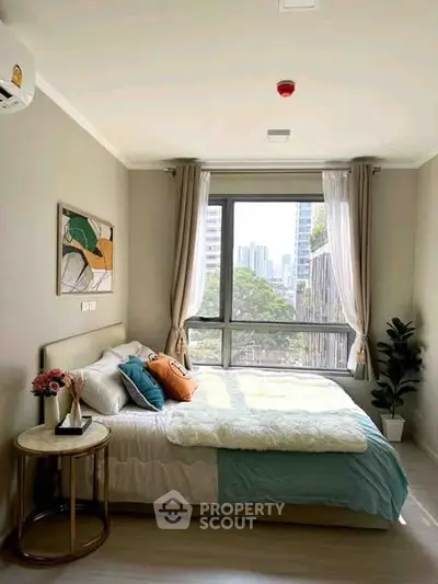 Bright and cozy bedroom with city view, modern decor, and large window.