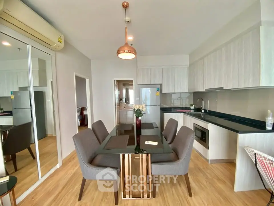 Modern dining area with sleek kitchen in open layout apartment