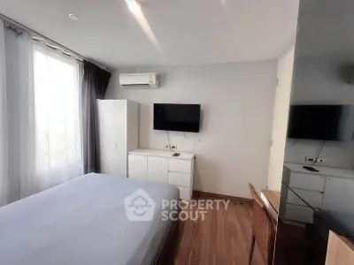Modern bedroom with sleek design, featuring a wall-mounted TV and air conditioning for ultimate comfort.