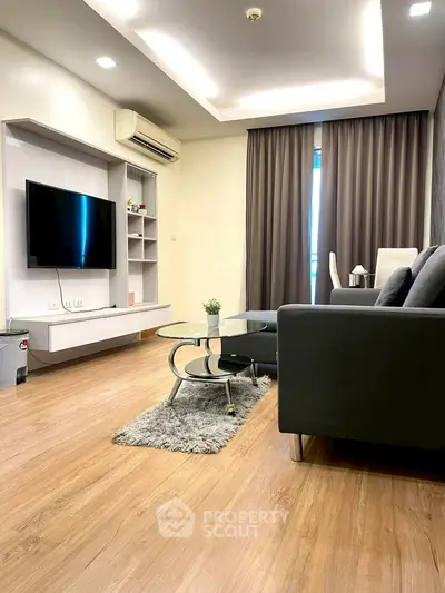 Modern living room with sleek furniture and wall-mounted TV