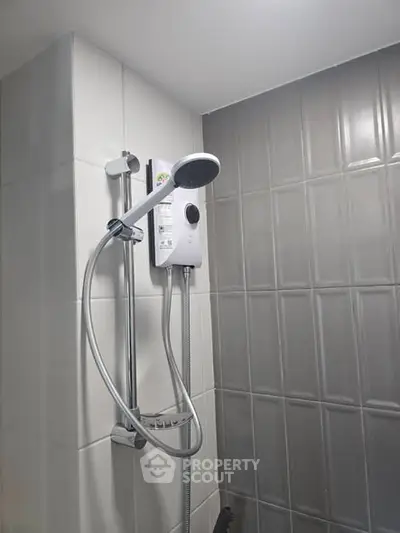Modern bathroom shower with sleek design and tiled walls, perfect for contemporary living.