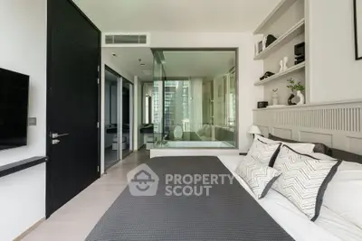 Modern bedroom with glass wall, stylish decor, and city view, perfect for urban living.