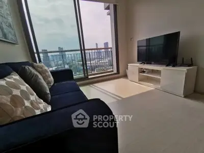 Modern living room with city view, sleek furniture, and large windows for natural light.