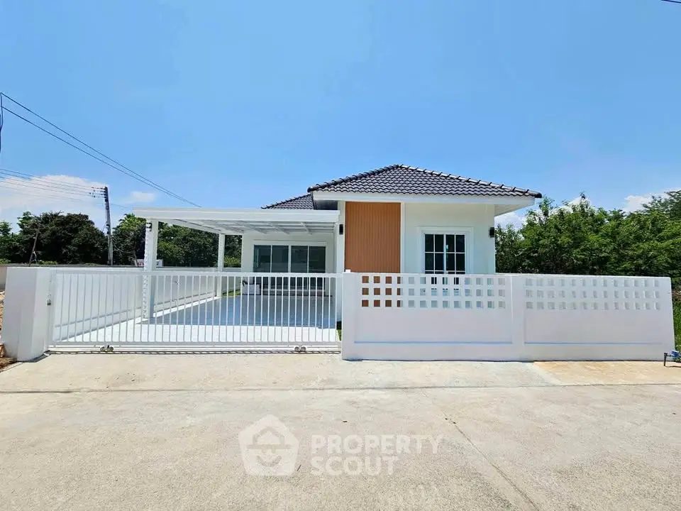 Charming single-story home with modern design and spacious driveway in a serene neighborhood.