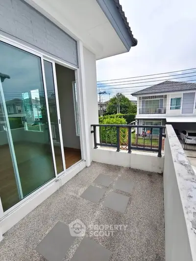 Charming balcony with modern railing and scenic neighborhood view, perfect for relaxation and outdoor enjoyment.