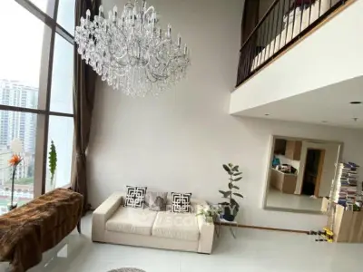 Luxurious high-ceiling living room with elegant chandelier and modern decor