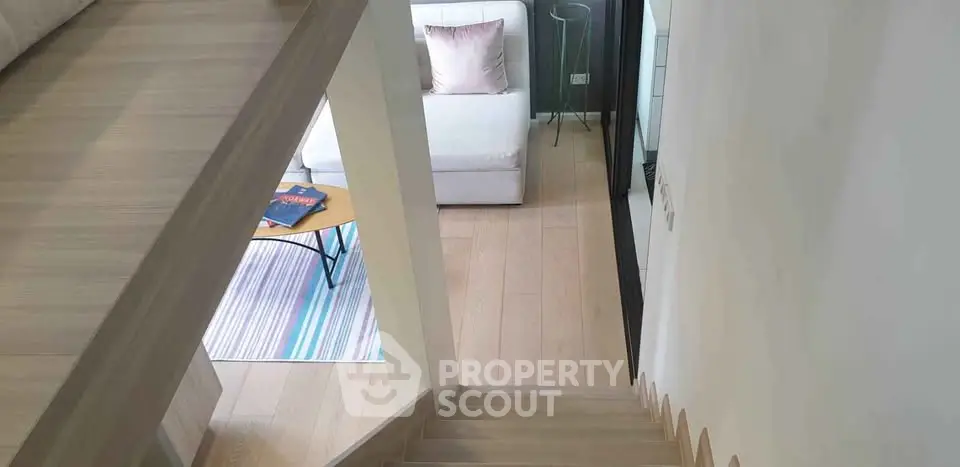 Modern living room with stylish staircase and cozy seating area