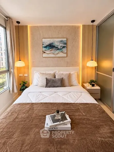Cozy bedroom with modern decor, featuring a plush bed, stylish lighting, and a serene wall art piece.