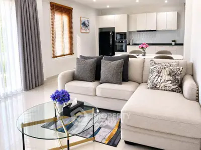 Modern living room with elegant decor and open kitchen layout