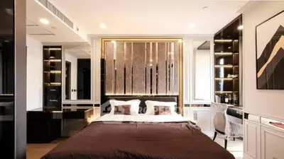 Luxurious modern bedroom with elegant decor and ambient lighting, featuring a stylish headboard and cozy bedding.