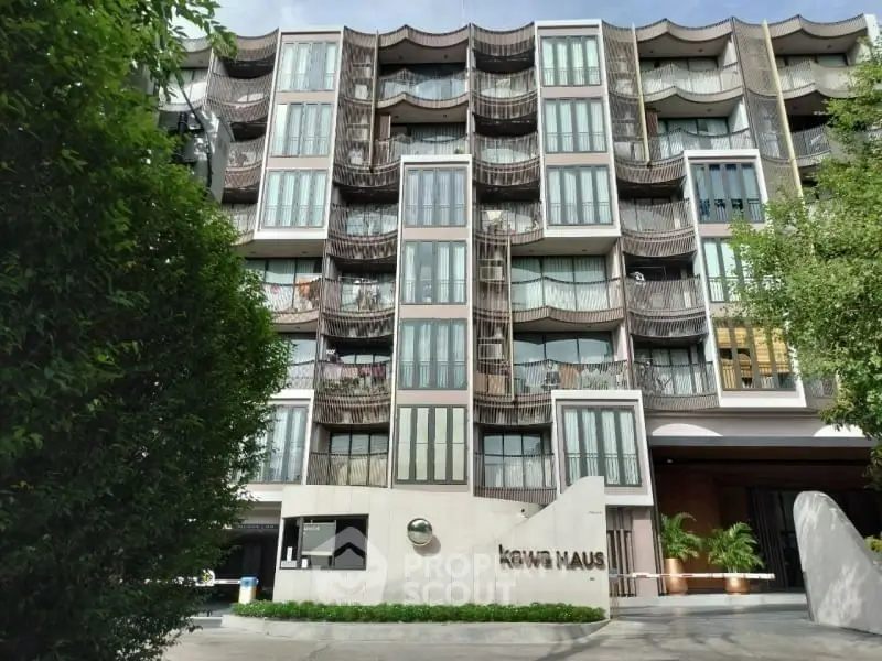 Modern apartment building with unique facade design and lush greenery
