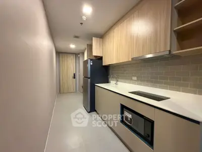 Modern kitchen with sleek cabinetry and built-in appliances in a stylish apartment.