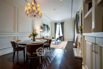 Luxurious living room with elegant chandelier and classic decor in upscale apartment.
