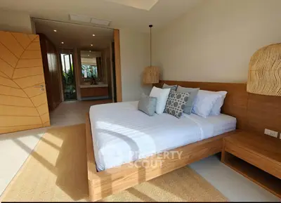 Luxurious bedroom with modern wooden furniture and elegant decor in a bright, spacious setting.