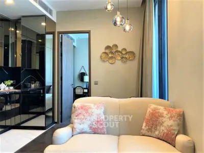 Elegant living room with modern decor and cozy seating in a stylish apartment.