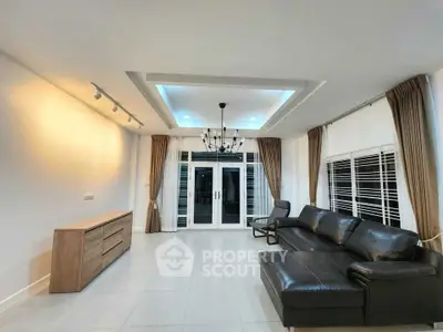 Spacious modern living room with elegant lighting and leather sofa