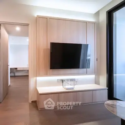 Modern living room with sleek TV setup and elegant wooden paneling