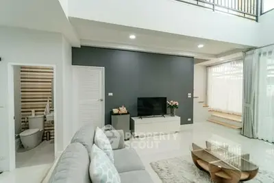 Spacious modern living room with high ceiling and elegant decor