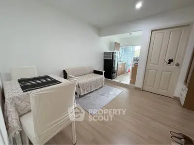 Cozy living room with dining area and open kitchen layout in modern apartment.