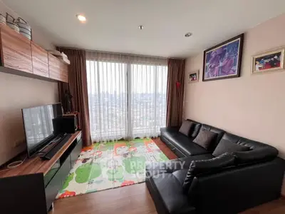Spacious living room with city view, modern furniture, and large windows for natural light.