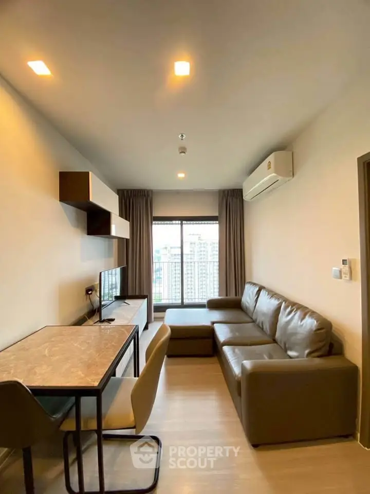 Modern living room with city view, featuring sleek furniture and stylish decor.
