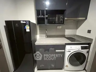 Compact modern kitchen with sleek appliances and efficient layout.