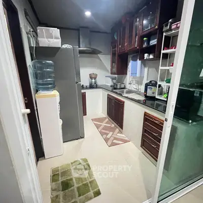 Cozy kitchen with modern appliances and ample storage space, featuring a closed layout and sleek design.