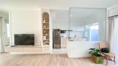 Modern open-plan living room with stylish kitchen and sleek appliances