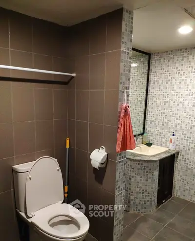 Modern bathroom with tiled walls and sleek fixtures