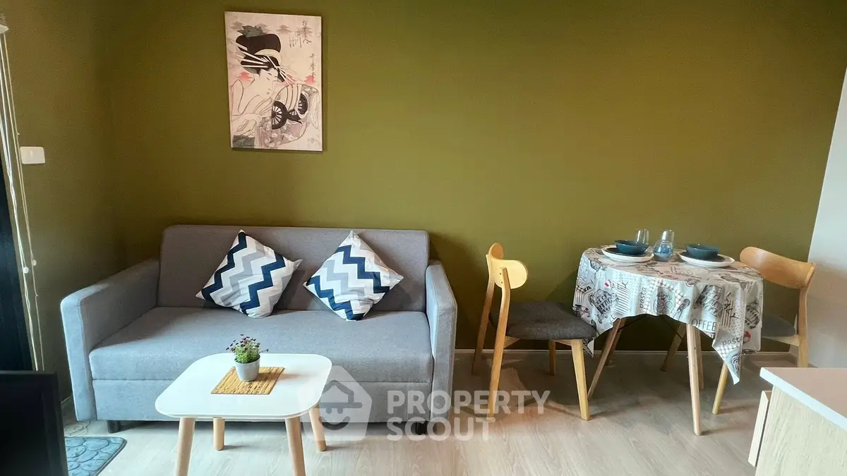 Cozy living room with modern decor and dining area in stylish apartment.