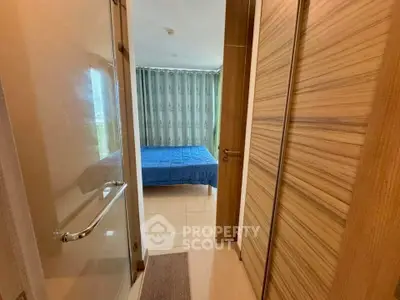 Cozy bedroom with wooden accents and blue bedding, offering a warm and inviting atmosphere.