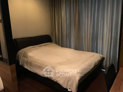 Cozy bedroom with modern decor and soft lighting, featuring a comfortable bed and elegant curtains.