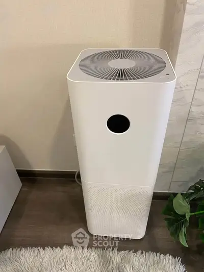 Modern air purifier in stylish living room setting with cozy decor