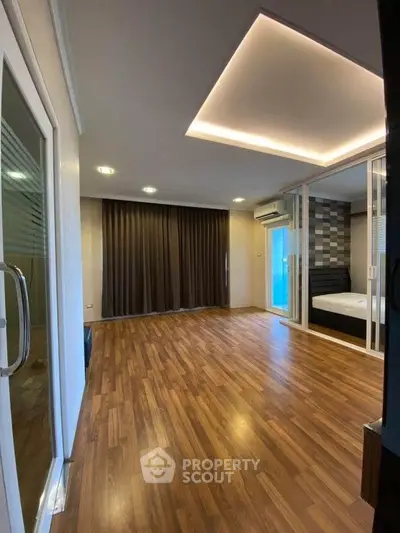 Modern living room with wooden flooring and stylish ceiling lights