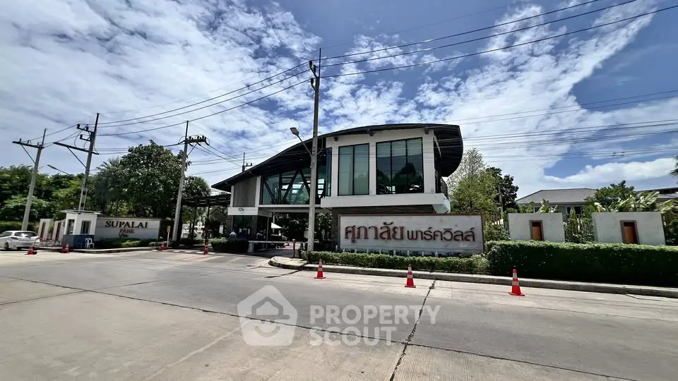 Modern building exterior with unique architecture and lush greenery, ideal for real estate investment.