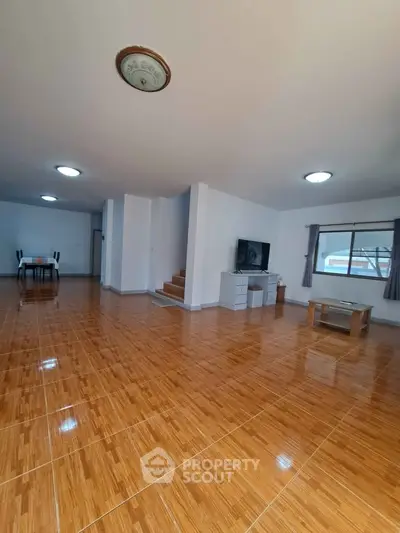Spacious living room with wooden flooring and modern decor