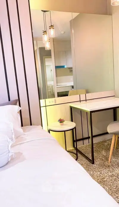 Modern bedroom with stylish decor and cozy ambiance, featuring a comfortable bed and elegant lighting.