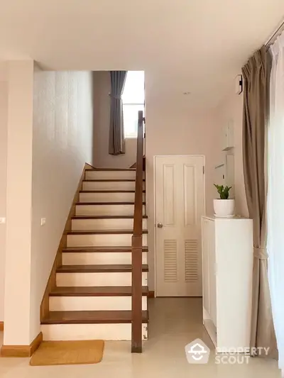 Elegant staircase with wooden railing in modern home interior