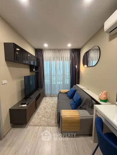 Modern living room with sleek furniture and large window for natural light.