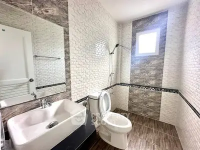 Modern bathroom with stylish tile design and natural light